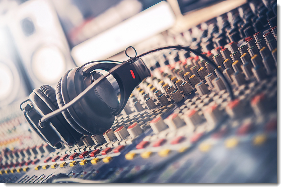 Close Up of Headphones and Mixing Desk